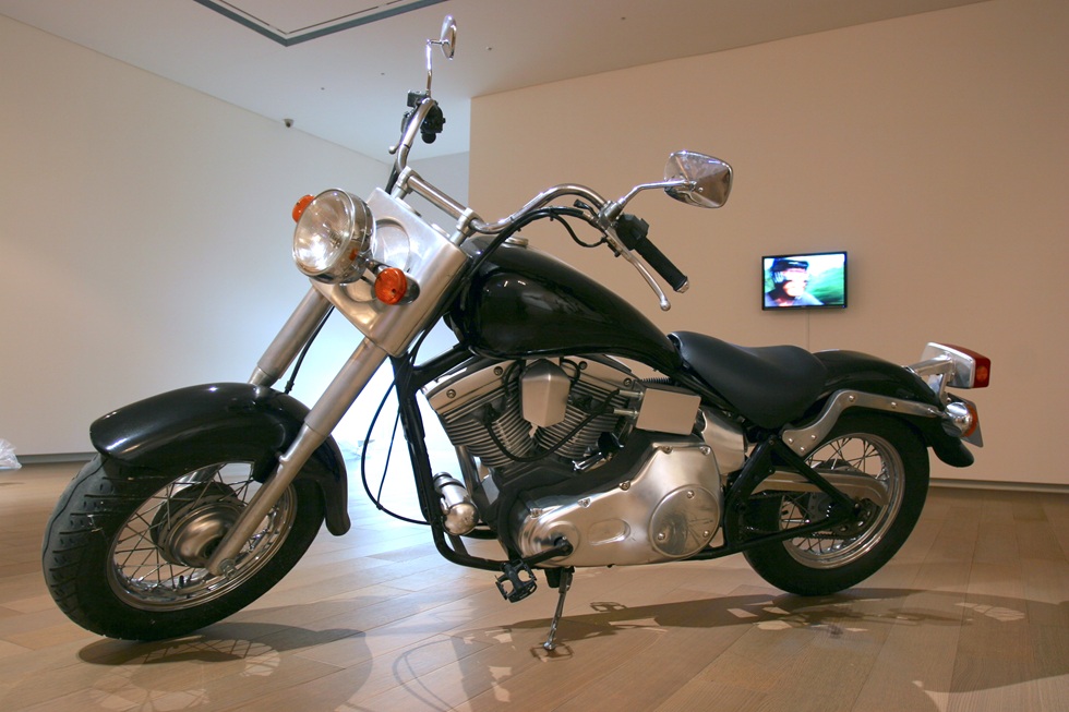 2009年廖建忠參展「抬頭一看，生活裡沒有任何美好的事」，作品《機車人生》於誠品畫廊展出一景。（廖建忠提供）